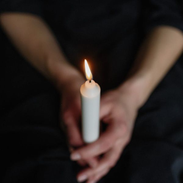 Person meditating peacefully with a glowing cyan aura around them.